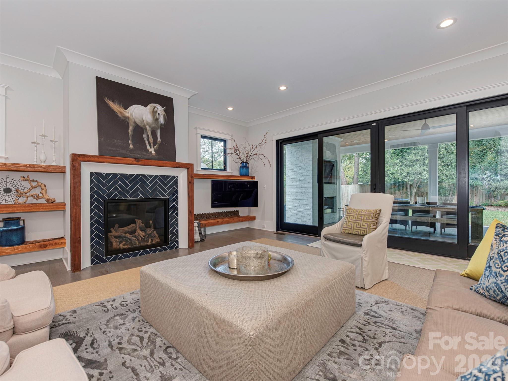 4009 Ridgecrest Avenue Charlotte, NC 28211 - Photo 43 of 43 a living room with furniture a rug a large window and a fireplace