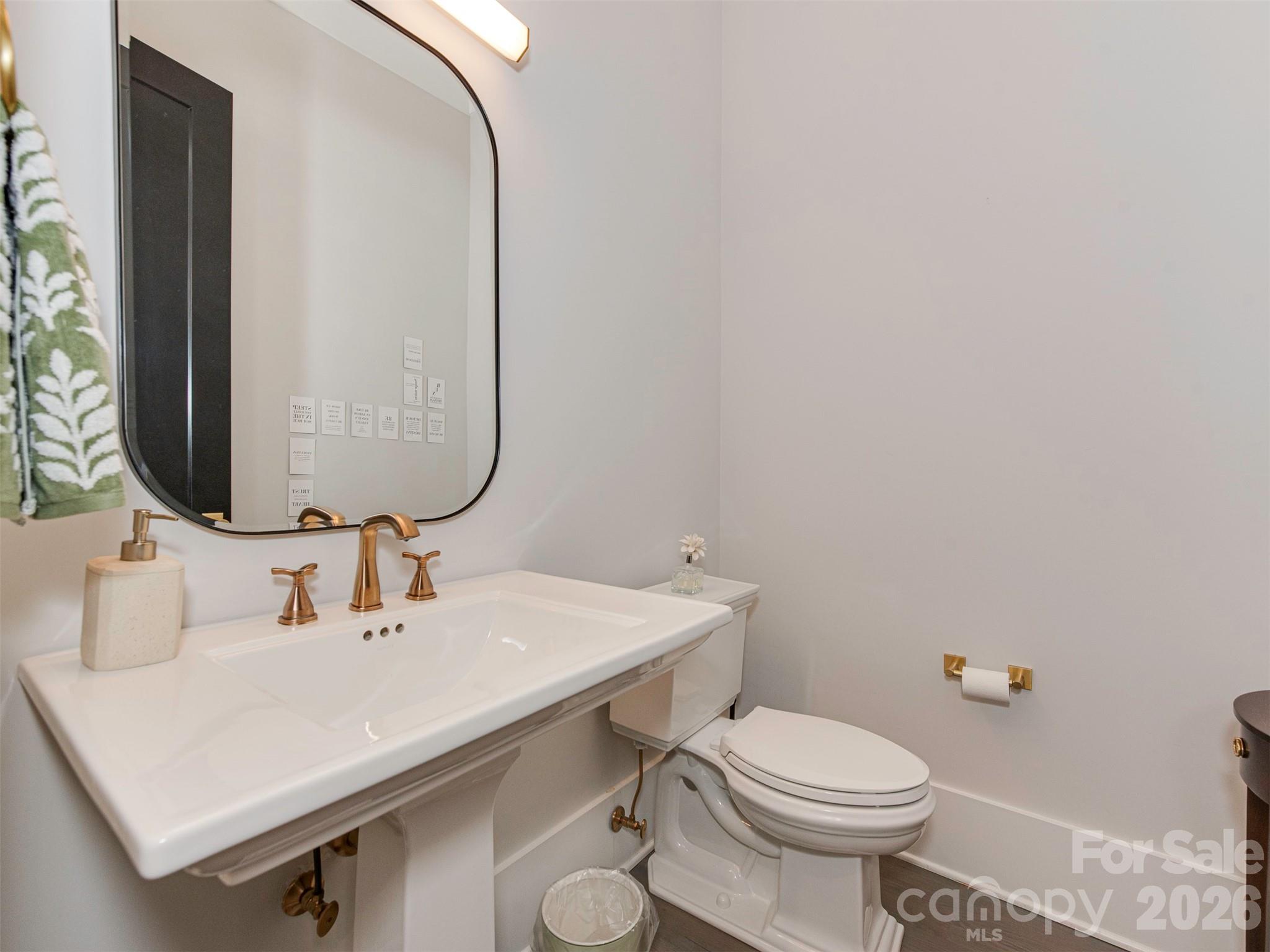 4009 Ridgecrest Avenue Charlotte, NC 28211 - Photo 5 of 43 a bathroom with a sink mirror and toilet
