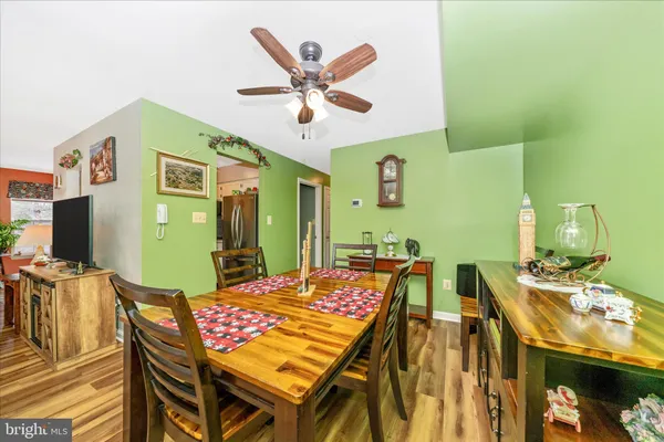 a view of a dining room with furniture and a chandelier