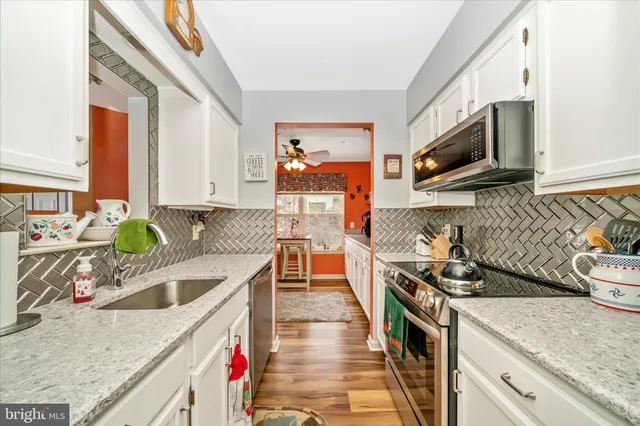 a kitchen with a stove a sink and a microwave