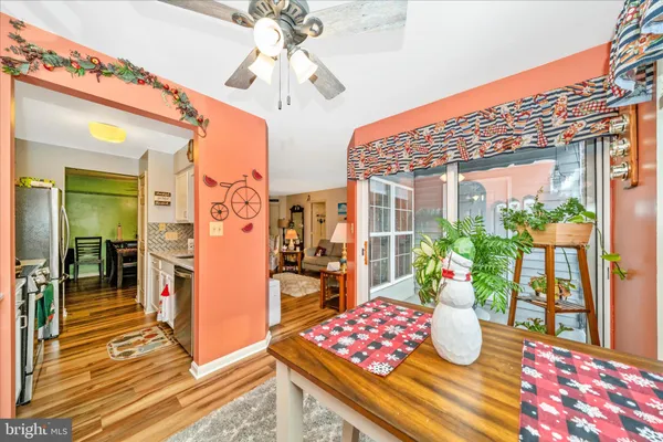 a view of a dining room with furniture a chandelier and wooden floor