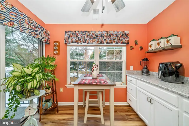 a kitchen with a large window and cabinets