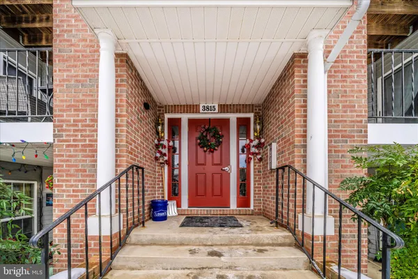 a view of a house with door and wooden stairs