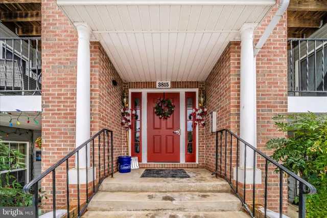 a view of a house with door and wooden stairs