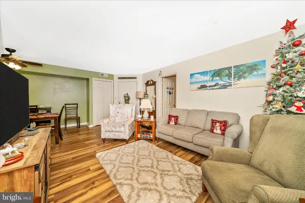 a living room with furniture and wooden floor