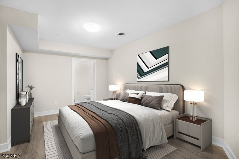 42 Spring Street, Unit 203 Morristown, NJ 07960 - Photo 4 of 15 a bedroom with a bed and lamp