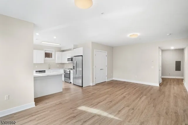a view of a kitchen with a sink and a refrigerator