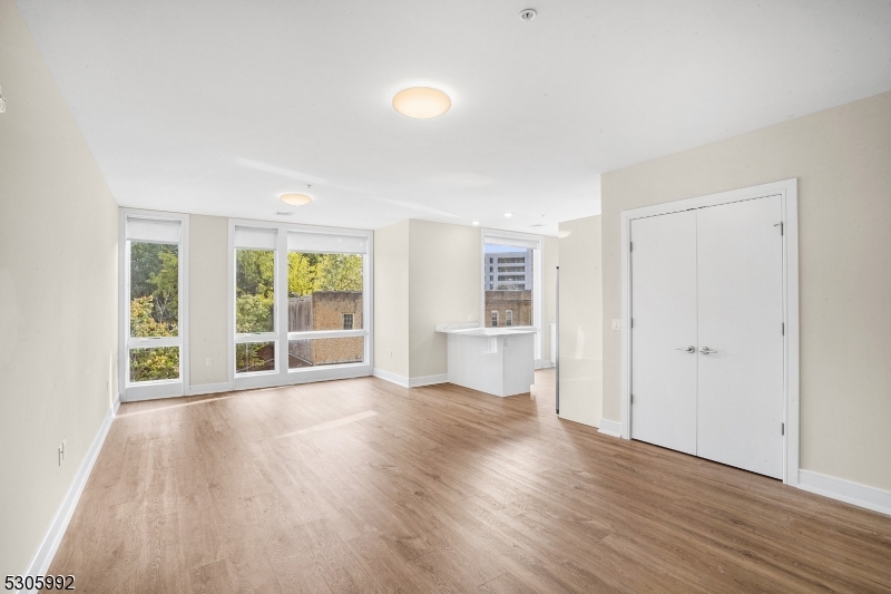 42 Spring Street, Unit 203 Morristown, NJ 07960 - Photo 7 of 15 an empty room with wooden floor and windows