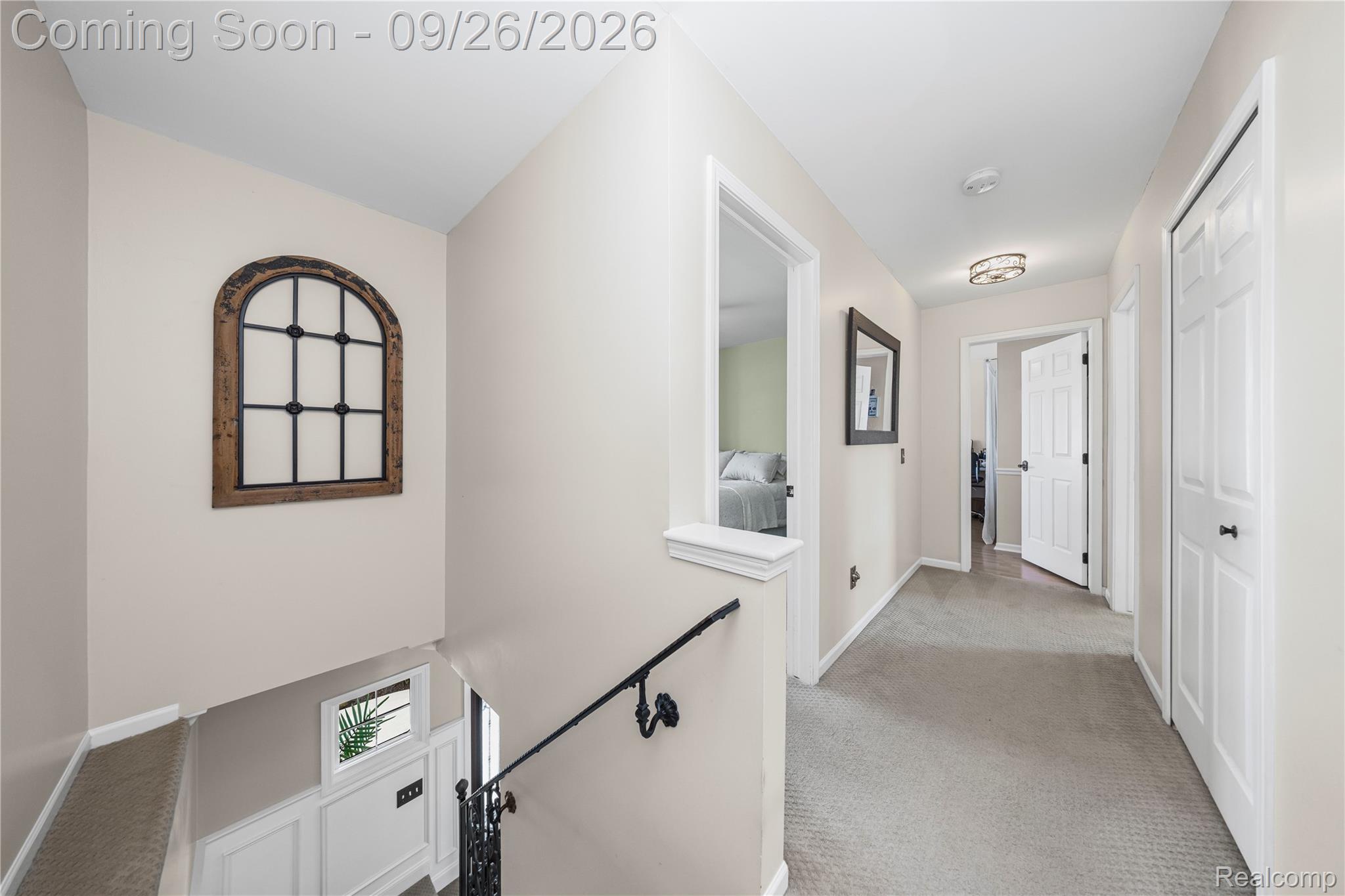 7021 Fox Path Canton, MI 48187 - Photo 31 of 59 Carpeted hallway with painted walls, multiple paneled doors, and a decorative flush mount light fixture