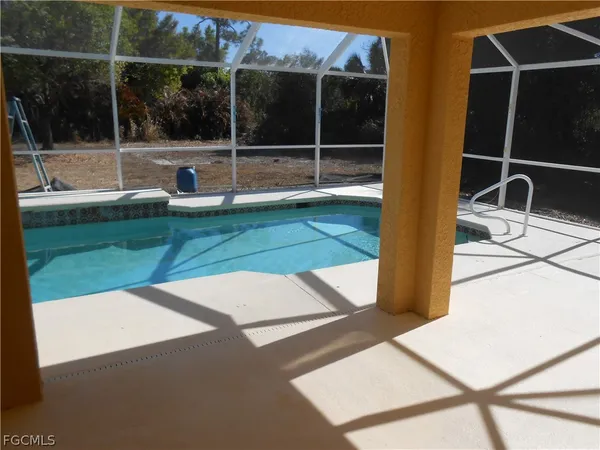 a backyard of a house with table and chairs