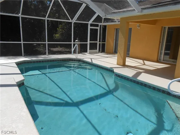 a swimming pool with outdoor seating