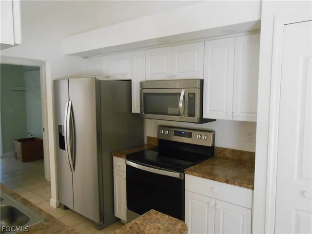 a kitchen with a stove and a refrigerator