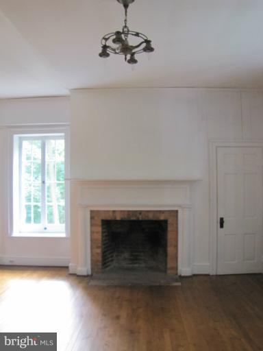 142 Falling Spring Road Shepherdstown, WV 25443 - Photo 21 of 27 an empty room with windows and fireplace