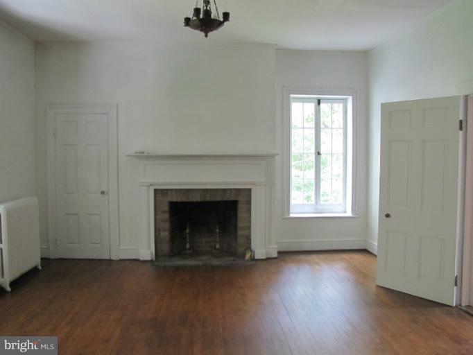142 Falling Spring Road Shepherdstown, WV 25443 - Photo 23 of 27 a view of an empty room with a fireplace and a window