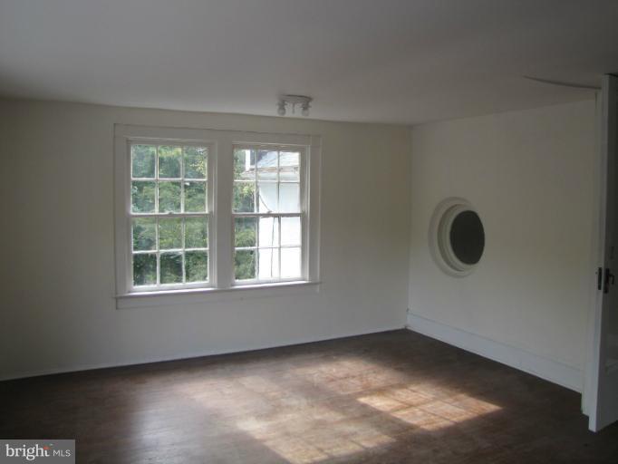 142 Falling Spring Road Shepherdstown, WV 25443 - Photo 24 of 27 an empty room with wooden floor and windows