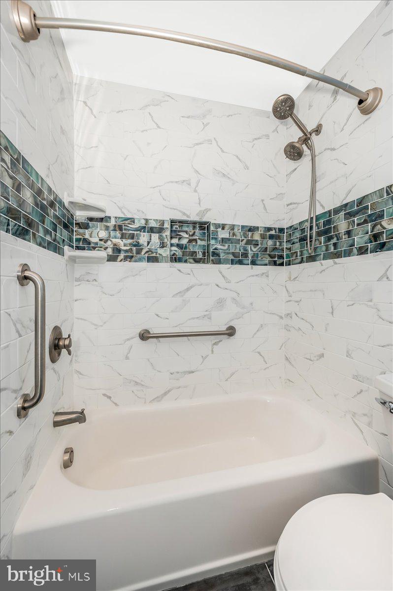 17305 Hoskinson Road Poolesville, MD 20837 - Photo 29 of 81 a bathroom with a shower and a toilet
