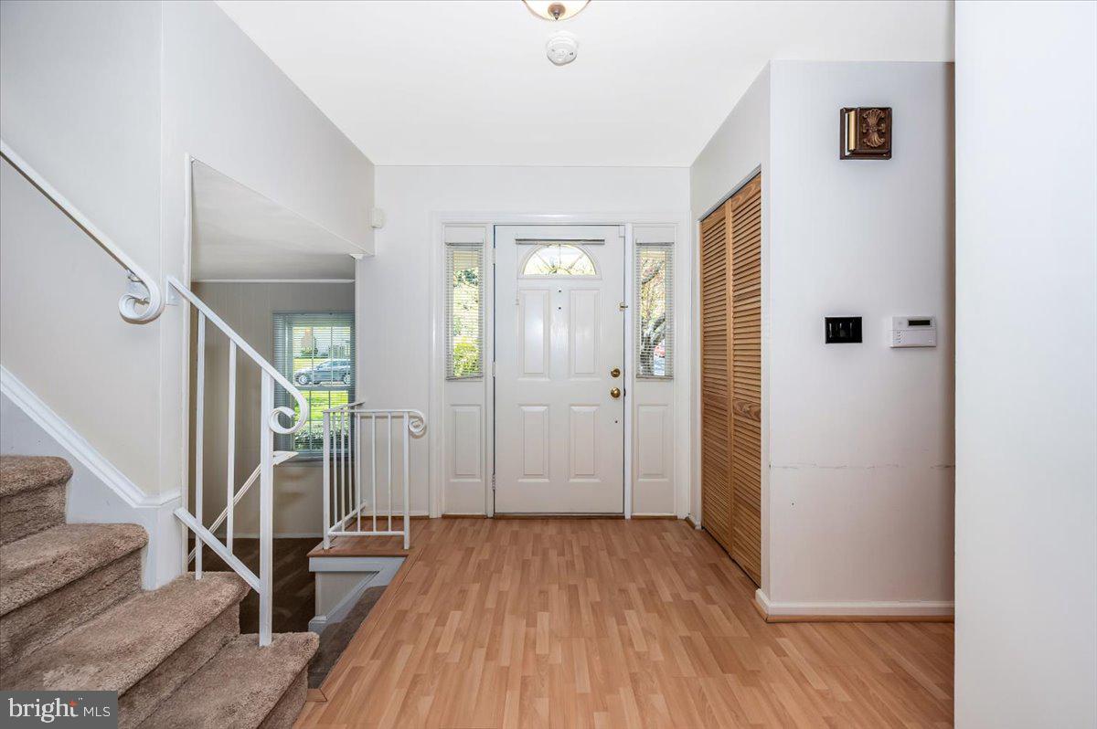 17305 Hoskinson Road Poolesville, MD 20837 - Photo 3 of 81 a view of a hallway with wooden floor and staircase