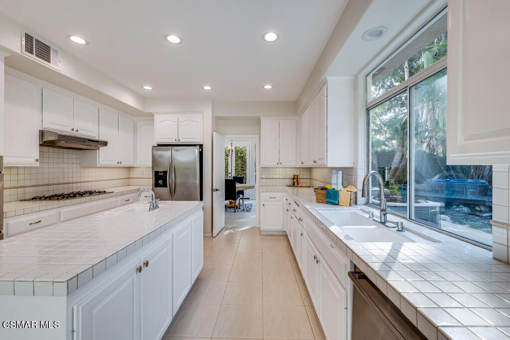 11292 Broadview Drive Moorpark, CA 93021 - Photo 26 of 58 a large kitchen with stainless steel appliances granite countertop a large stove a sink and a refrigerator