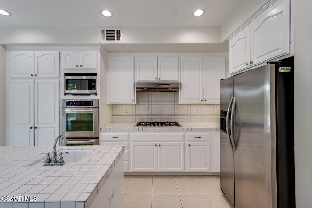 11292 Broadview Drive Moorpark, CA 93021 - Photo 30 of 58 a kitchen with stainless steel appliances granite countertop a stove and a refrigerator