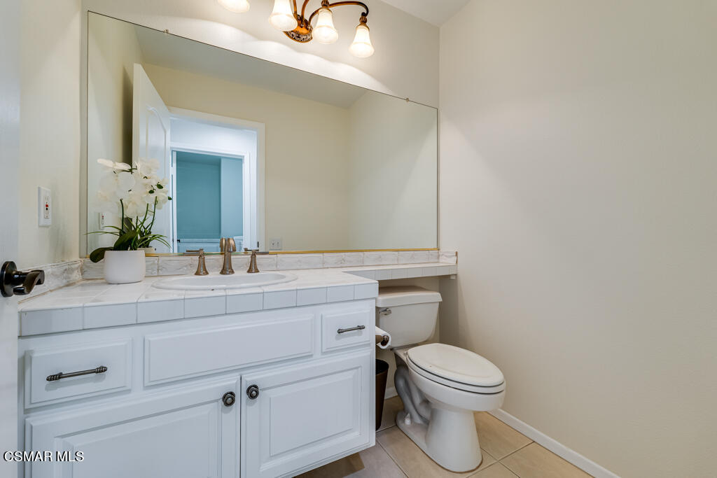 11292 Broadview Drive Moorpark, CA 93021 - Photo 31 of 58 a bathroom with a toilet a sink and mirror