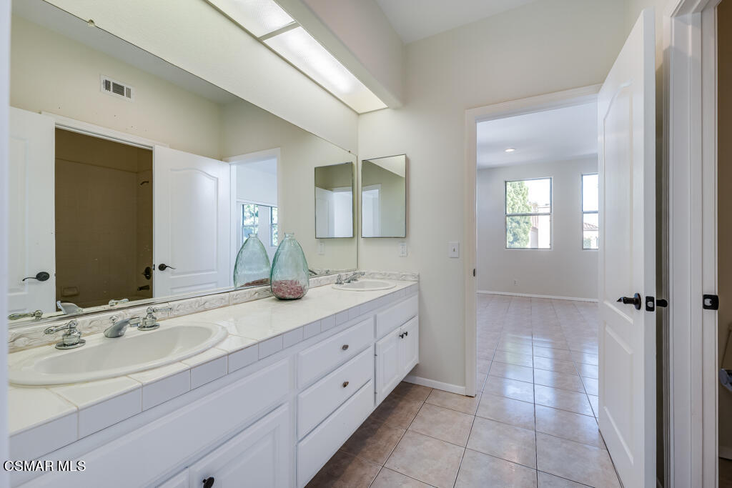 11292 Broadview Drive Moorpark, CA 93021 - Photo 36 of 58 a bathroom with a double vanity sink and a mirror