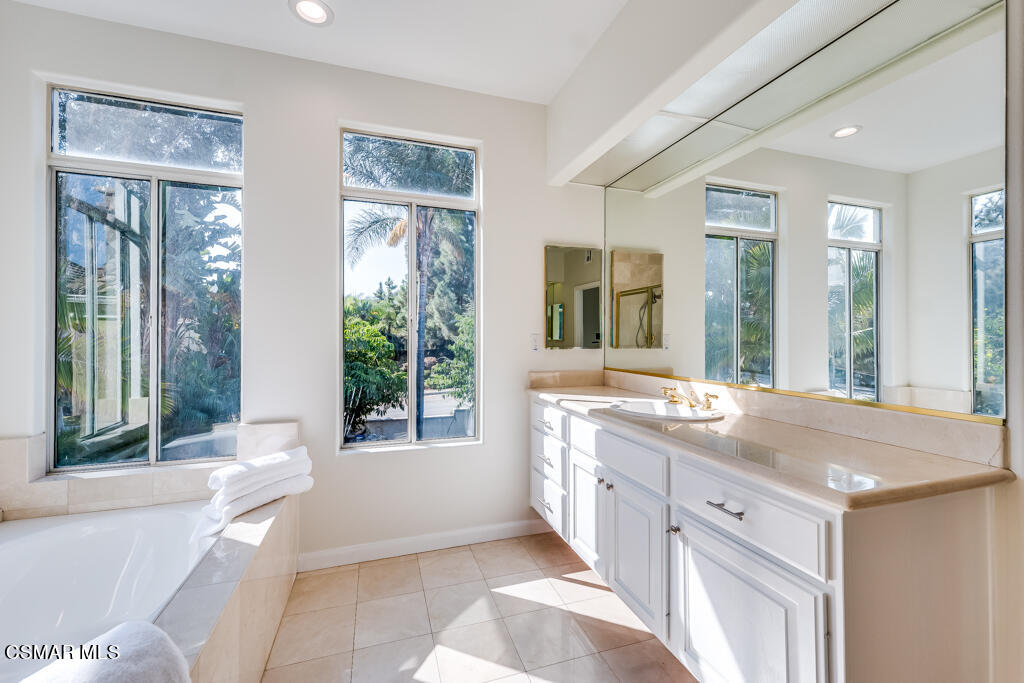 11292 Broadview Drive Moorpark, CA 93021 - Photo 45 of 58 a spacious bathroom with a granite countertop tub and a sink