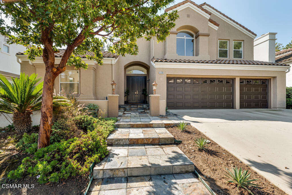 11292 Broadview Drive Moorpark, CA 93021 - Photo 5 of 58 a front view of a house with a yard and garage