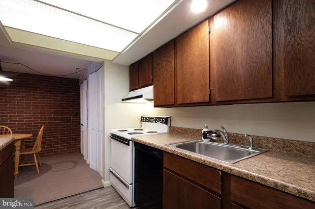 a bathroom with a sink a toilet a shower and a mirror