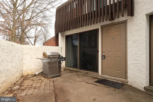a living room with furniture and potted plants
