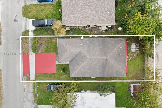 an aerial view of residential house with outdoor space and swimming pool