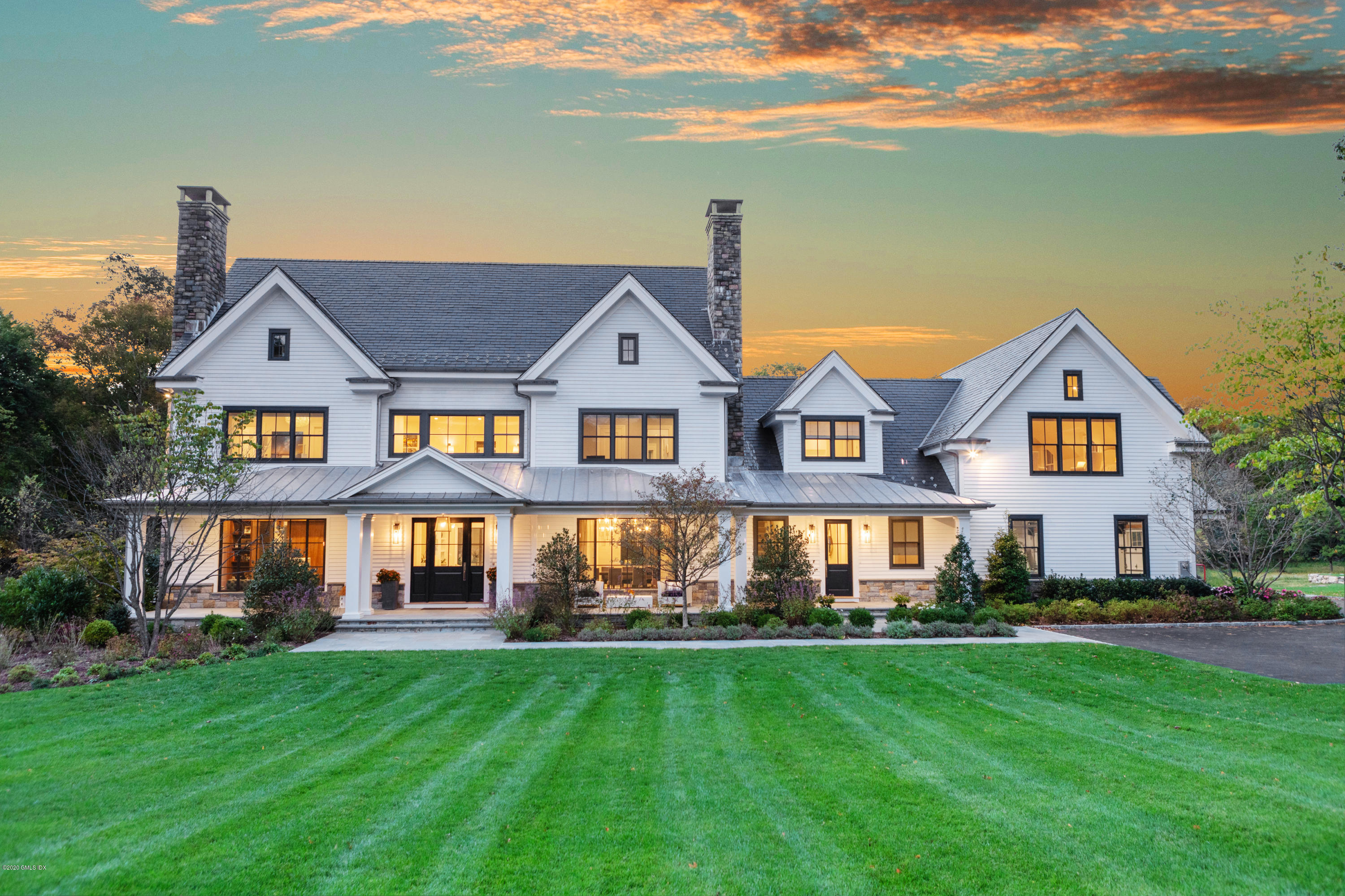 201 Clapboard Ridge Road Greenwich, CT 06831 - Photo 1 of 28 a front view of a house with a yard and lake view