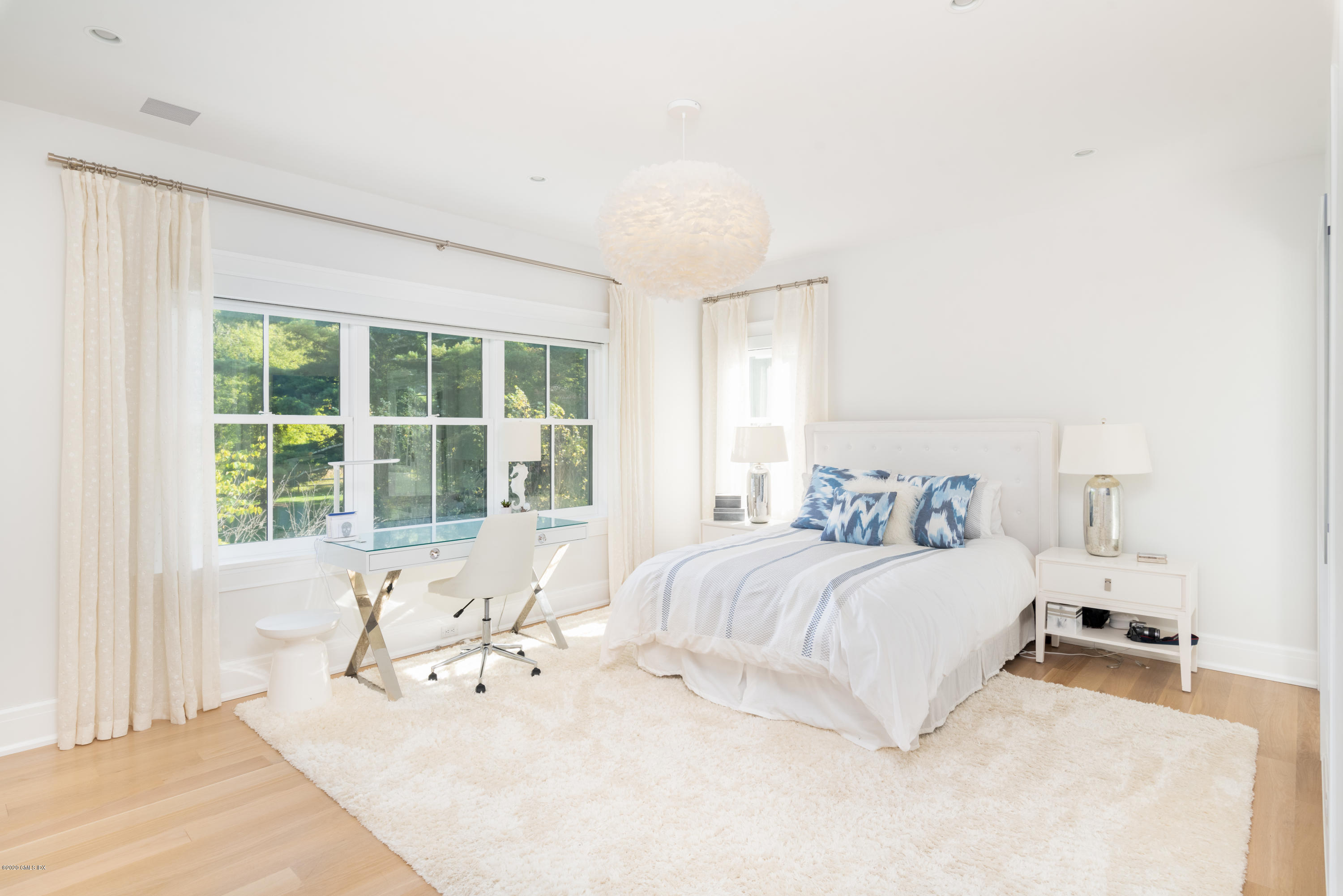 201 Clapboard Ridge Road Greenwich, CT 06831 - Photo 18 of 28 a spacious bedroom with a bed and a large window