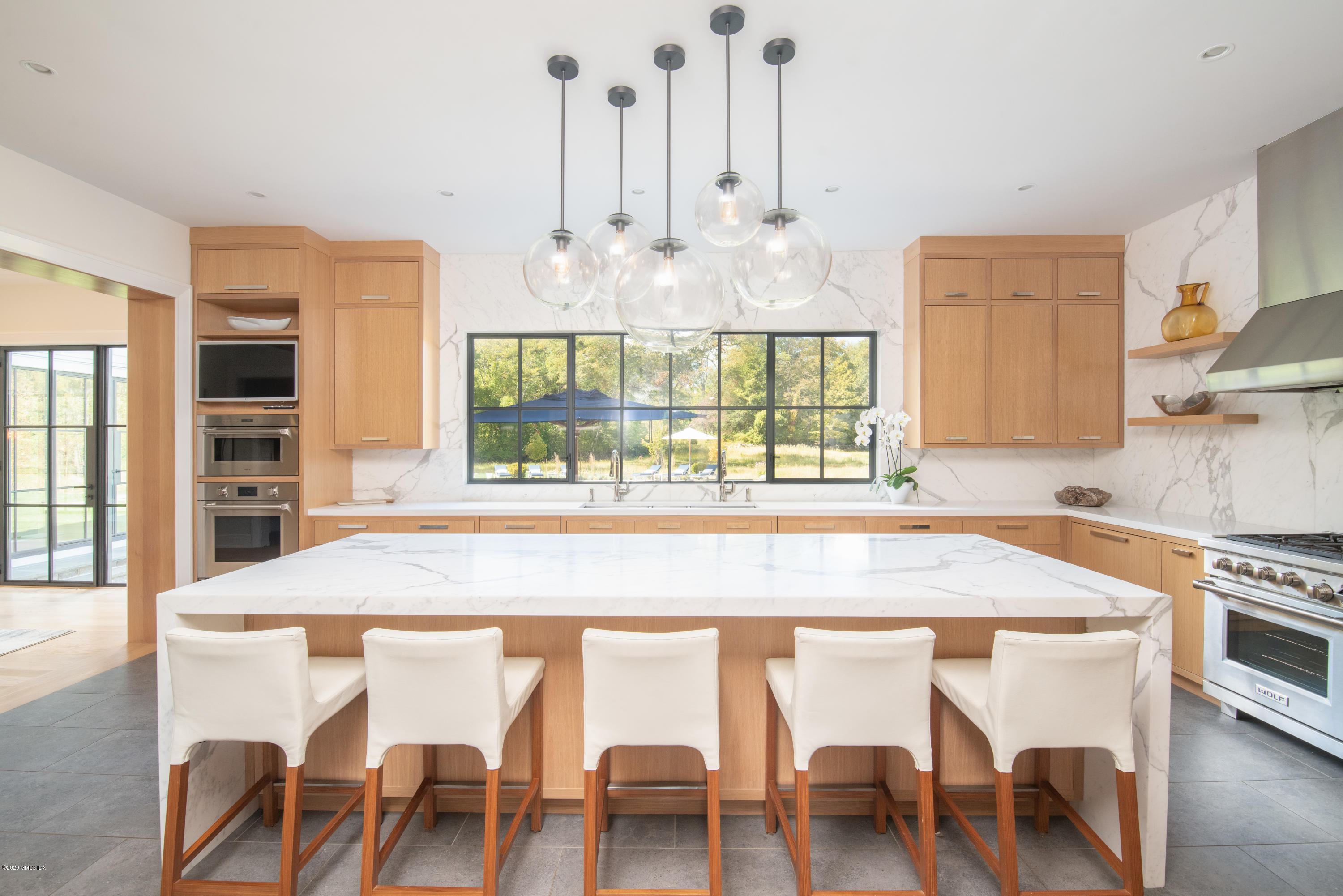 201 Clapboard Ridge Road Greenwich, CT 06831 - Photo 4 of 28 a dining table with chairs and wooden floor