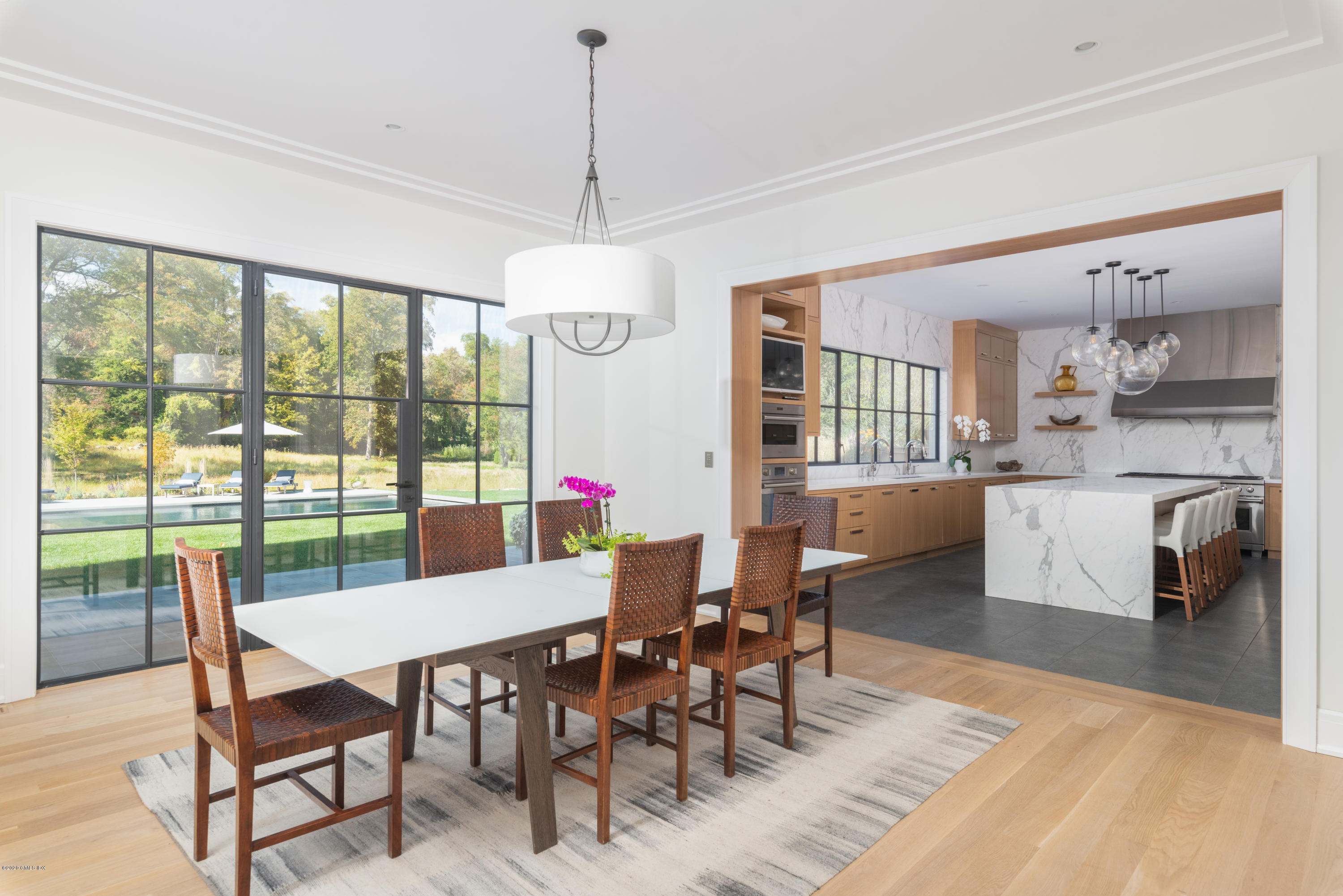 201 Clapboard Ridge Road Greenwich, CT 06831 - Photo 6 of 28 a view of a dining room and livingroom with furniture wooden floor a chandelier