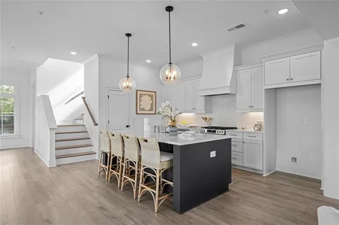 a view of a dining room with furniture wooden floor and chandelier