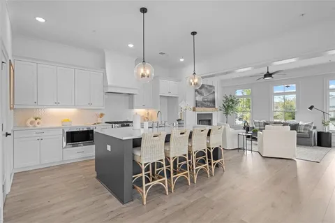 a kitchen with stainless steel appliances a stove a chandelier and a refrigerator