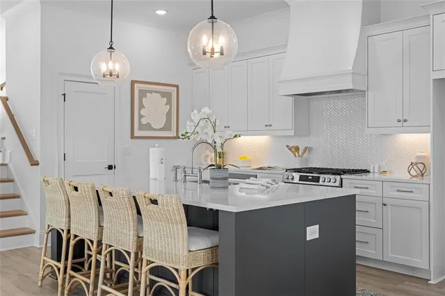 a kitchen with stainless steel appliances a sink stove and cabinets