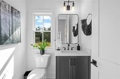 a kitchen with stainless steel appliances a stove a sink dishwasher and white cabinets with wooden floor