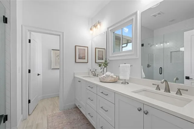 a bathroom with a sink double vanity and a mirror