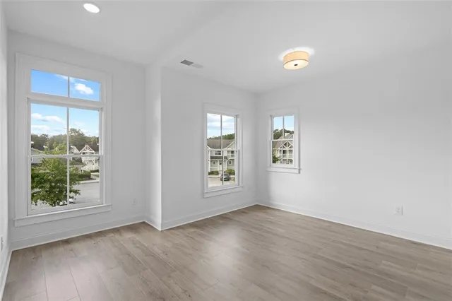 a view of a balcony with floor to ceiling windows with wooden floor