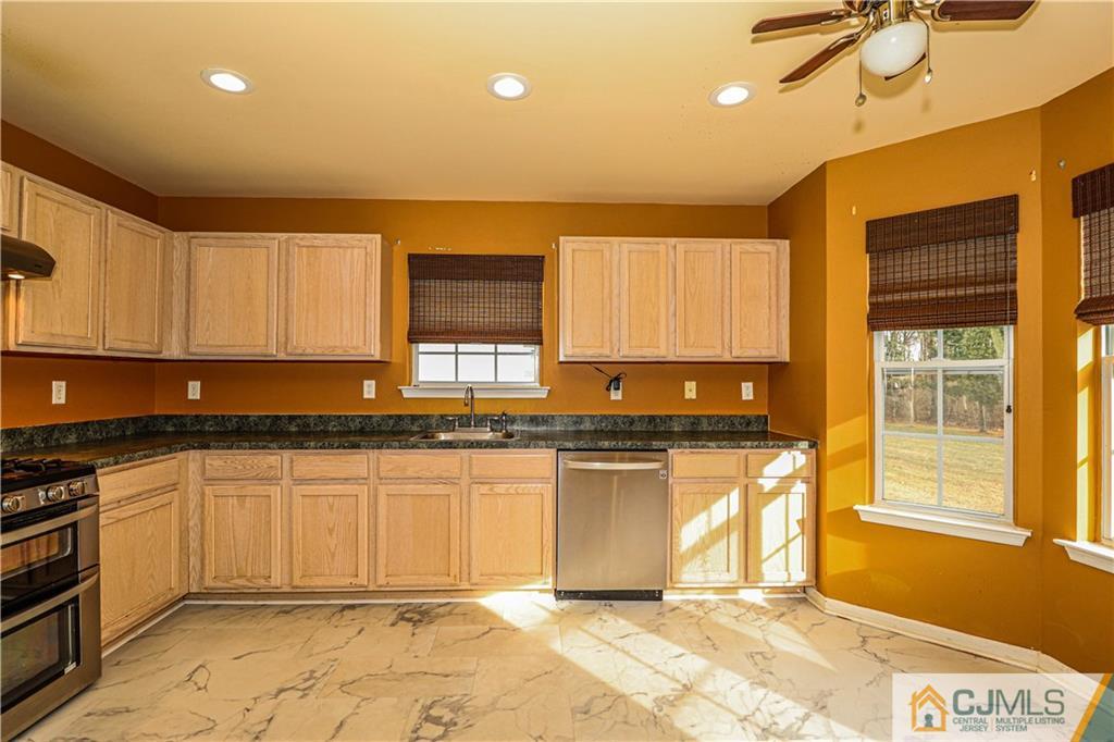 30 Hawthorne Road North Brunswick, NJ 08902 - Photo 15 of 40 a kitchen with stainless steel appliances granite countertop a stove a sink and a microwave