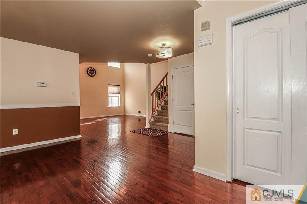 30 Hawthorne Road North Brunswick, NJ 08902 - Photo 17 of 40 a view of an empty room with wooden floor and a window