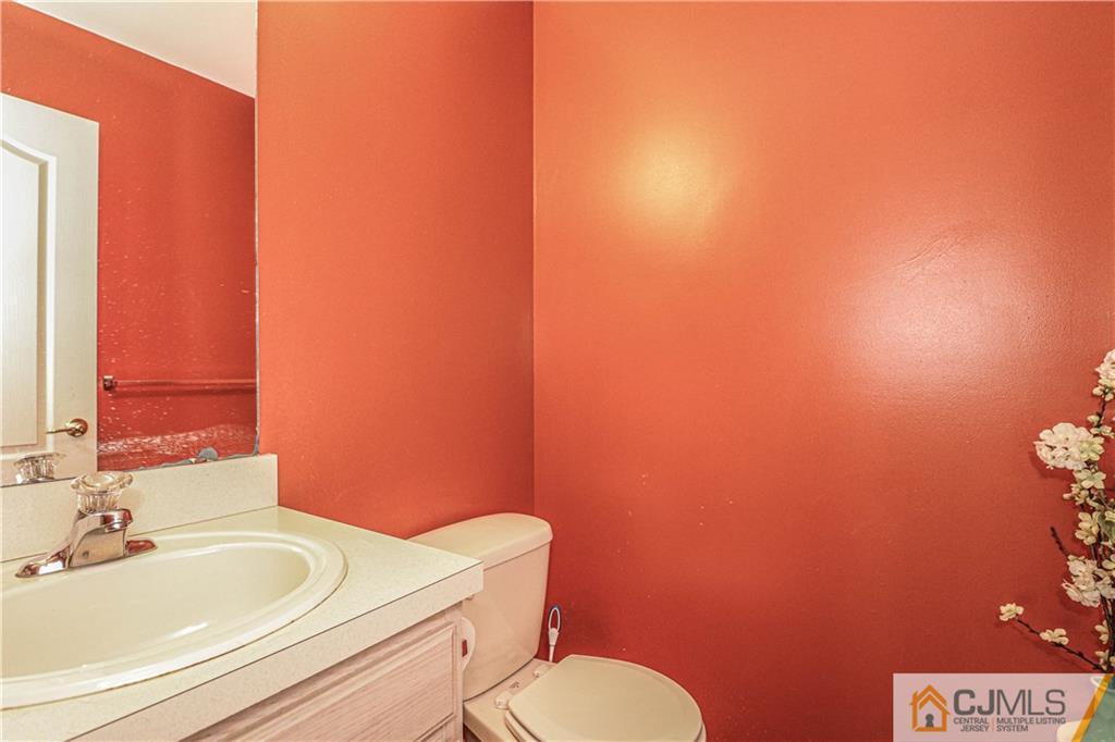 30 Hawthorne Road North Brunswick, NJ 08902 - Photo 23 of 40 a bathroom with a toilet a sink and mirror