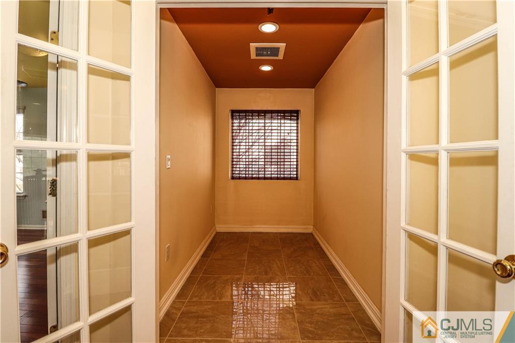 30 Hawthorne Road North Brunswick, NJ 08902 - Photo 29 of 40 a view of a hallway with wooden floor and a window