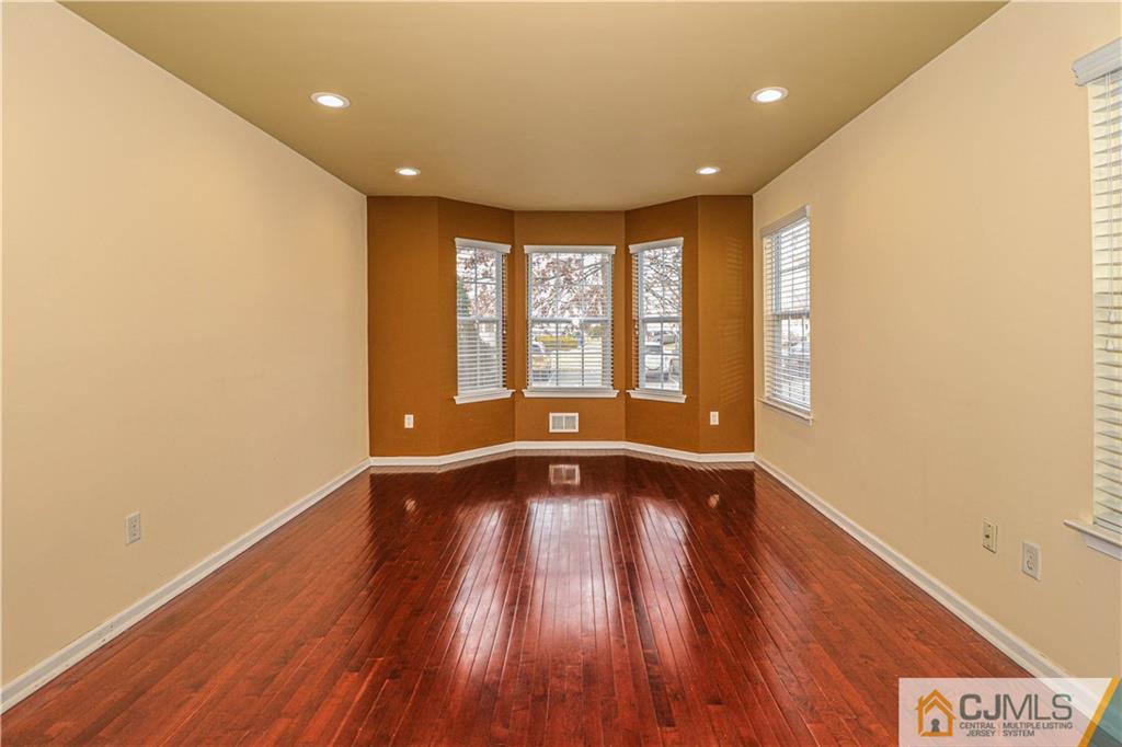 30 Hawthorne Road North Brunswick, NJ 08902 - Photo 4 of 40 a view of an empty room with wooden floor and a window