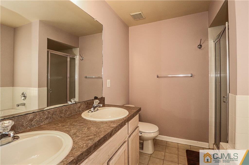 30 Hawthorne Road North Brunswick, NJ 08902 - Photo 33 of 40 a bathroom with a granite countertop sink toilet and shower