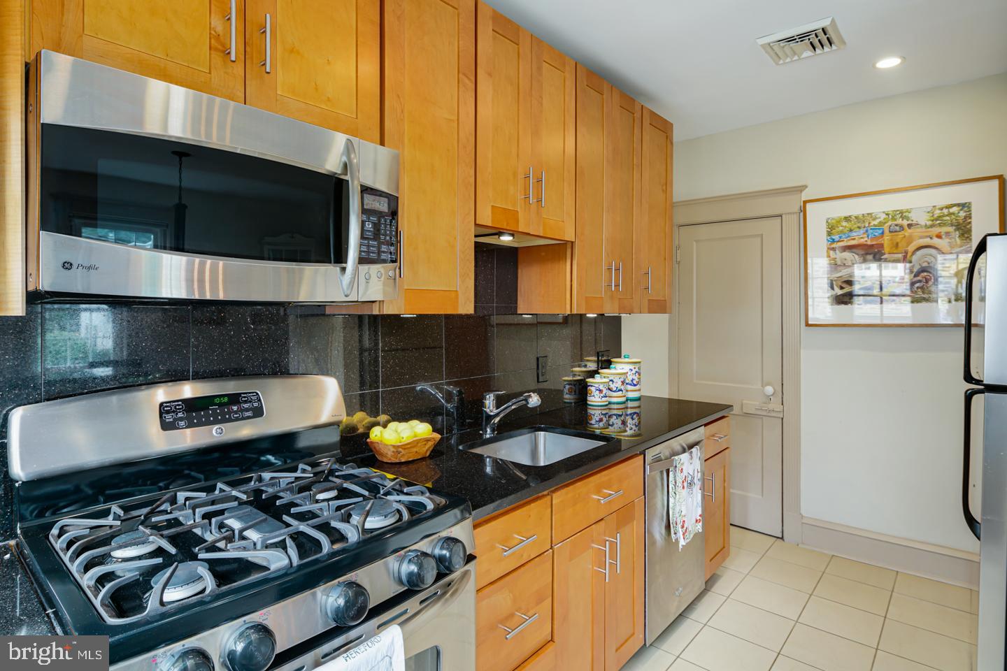 54 Wellington Road Ardmore, PA 19003 - Photo 14 of 26 a kitchen with stainless steel appliances granite countertop a stove and a microwave