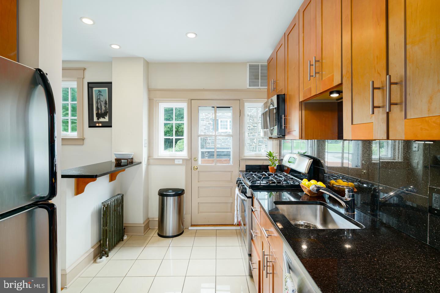 54 Wellington Road Ardmore, PA 19003 - Photo 15 of 26 a kitchen with granite countertop a sink a counter top space appliances and cabinets