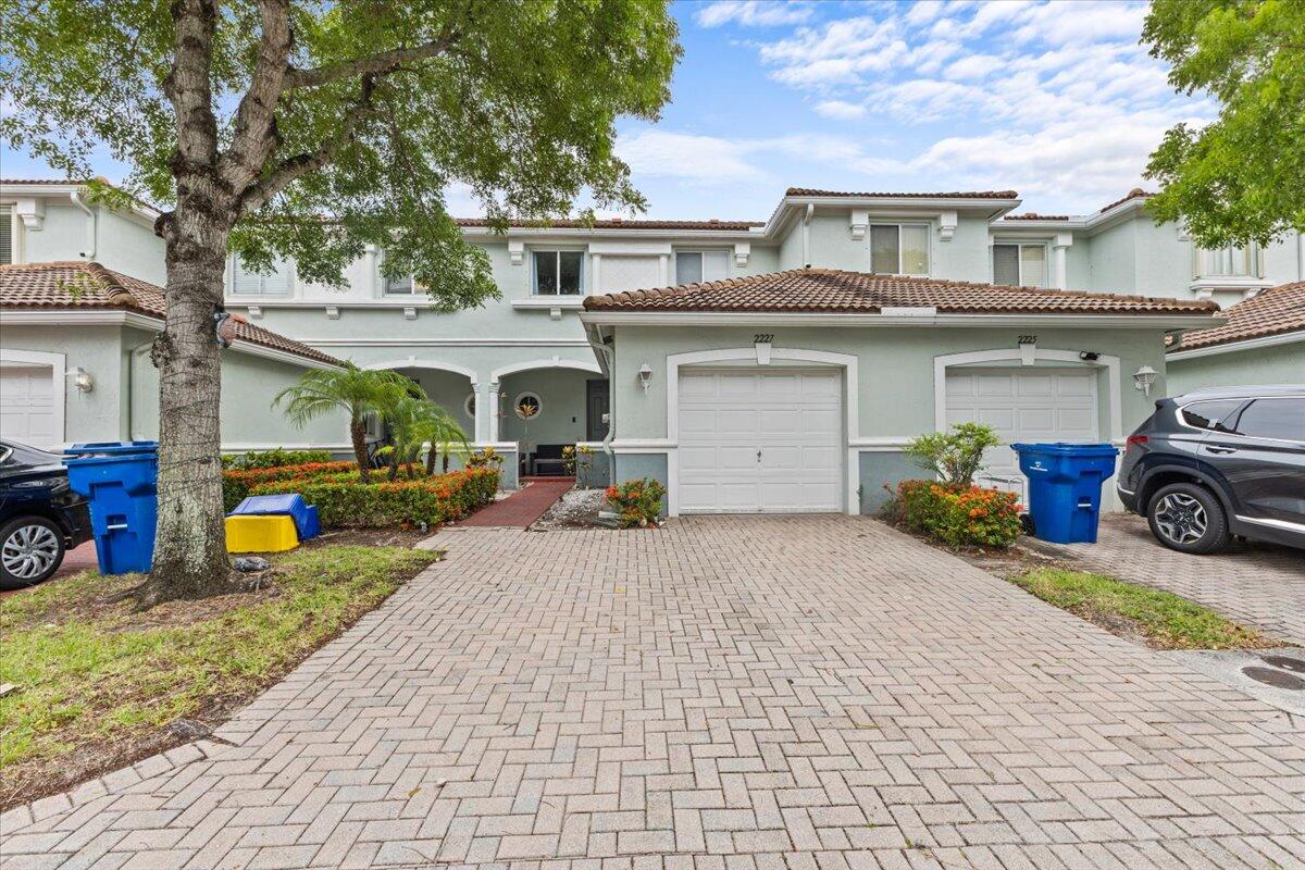 2227 Oakmont Drive Riviera Beach, FL 33404 - Photo 1 of 43 a view of a car park in front of house