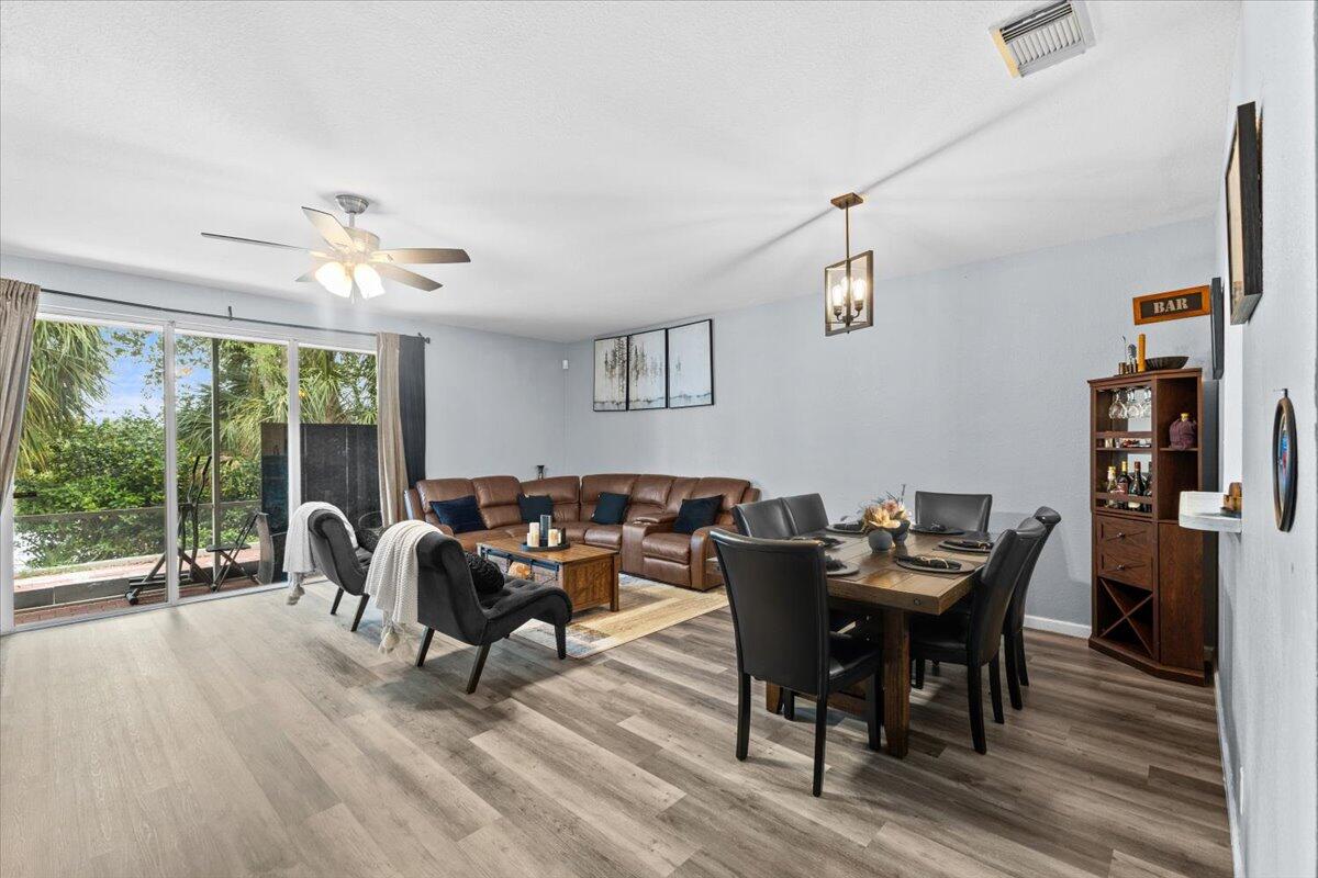 2227 Oakmont Drive Riviera Beach, FL 33404 - Photo 11 of 43 a work room with furniture and wooden floor